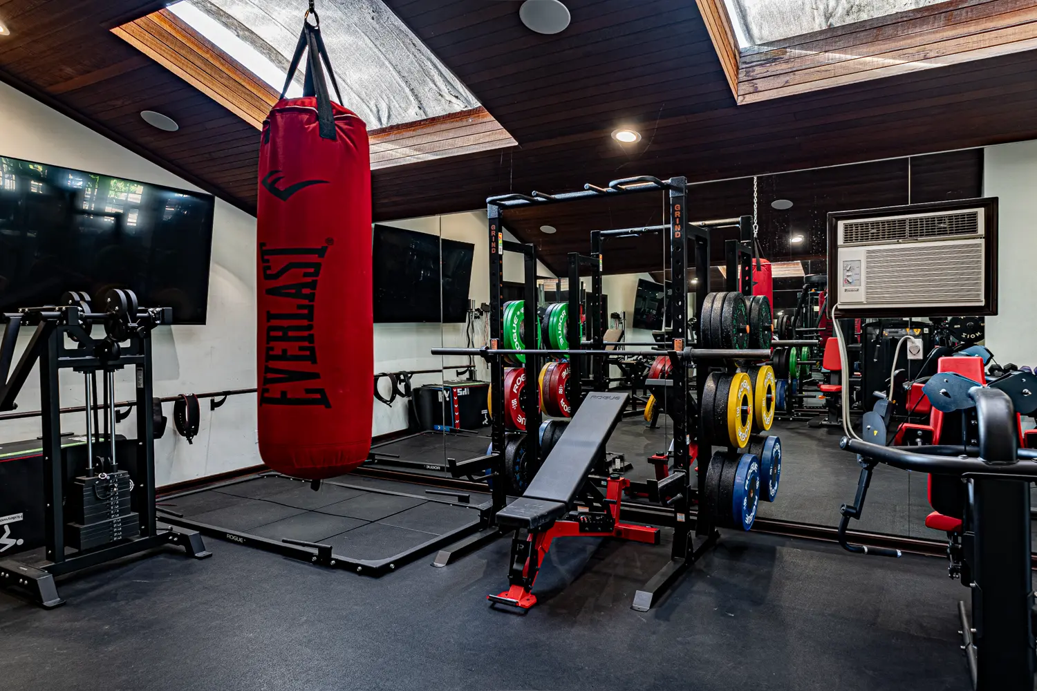 Deadlift platform beside a mirrored rack wall